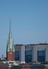 Church tower and skyscrapers in down town, a winter day in Stockholm