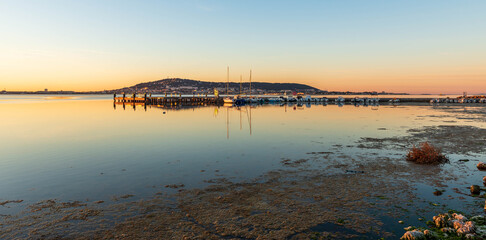Sunrise, on the Etang de Thau, in Balaruc-les-Bains, on the Etang de Thau, and S&egrave;te in the background.