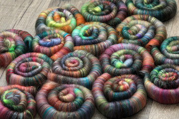 Closeup detail of handmade rolags of sheep wool and other fibres which were blended on a blending...