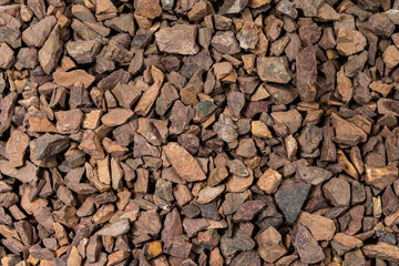 Close-up Image of Background Made of Pile of Colorful Brown, Yellow and Red Crushed Stones.