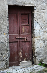 Old wooden door of a house in rural areas of Italy