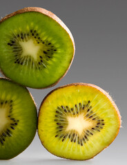 vertical sheets of kiwi in gray background