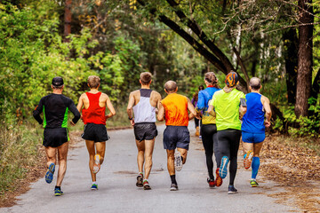 group athletes man runners running race in autumn park