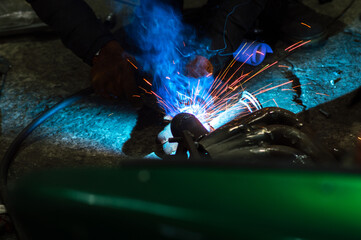  welder performs welding works of metal structures for custom cars