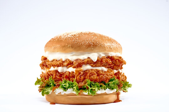 Double Chicken burger with ketchup, cheese, and mayonnaise on isolated white background.