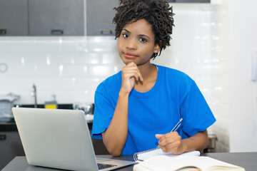 Portrait of learning african american female student at computer