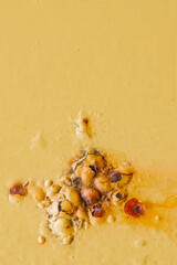 Abstract of rust bubbling through a mustard coloured painted panel