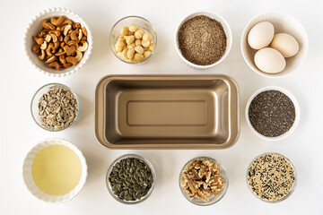 Top view of healthy gluten free, lactose free, hight protein, keto bread ingredients with metal bread mould