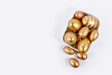 Painted golden Easter eggs with stripes and dots