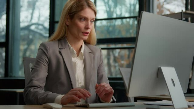 Caucasian adult 40s businesswoman typing computer in office tired sleepy sitting at office desk exhausted bored middle-aged woman overworked lazy lady worker executive feel fatigue of online work job
