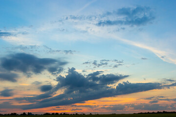 clouds in the sky illuminated by the sun summer evening. background