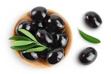 Black olives with leaves in wooden bowl isolated on a white background with full depth of field. Top view. Flat lay