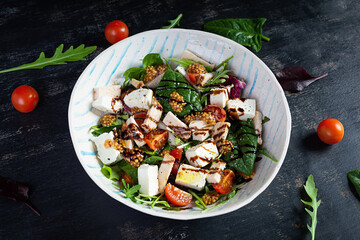 Fresh salad with chicken, tomatoes, herbs and feta cheese. Healthy food
