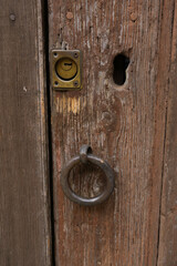 Wooden door with an iron ring and a bolt