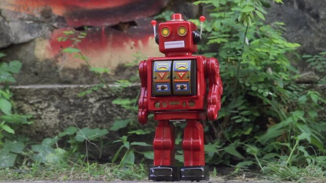 red vintage robot in an urban setting marching and spinning 