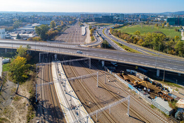 Railroad trackage with many track, electric traction and highway junction in Krakow, Poland, near Kraków Bonarka railway station - obrazy, fototapety, plakaty