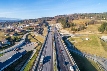 Poland. Zakopianka highway with newly opened tunnel in November 2022. It makes travel from Krakow to Zakopane and Slovakia much faster. Multilevel crossroad with viaducts, slip roads and traffic - 573483647