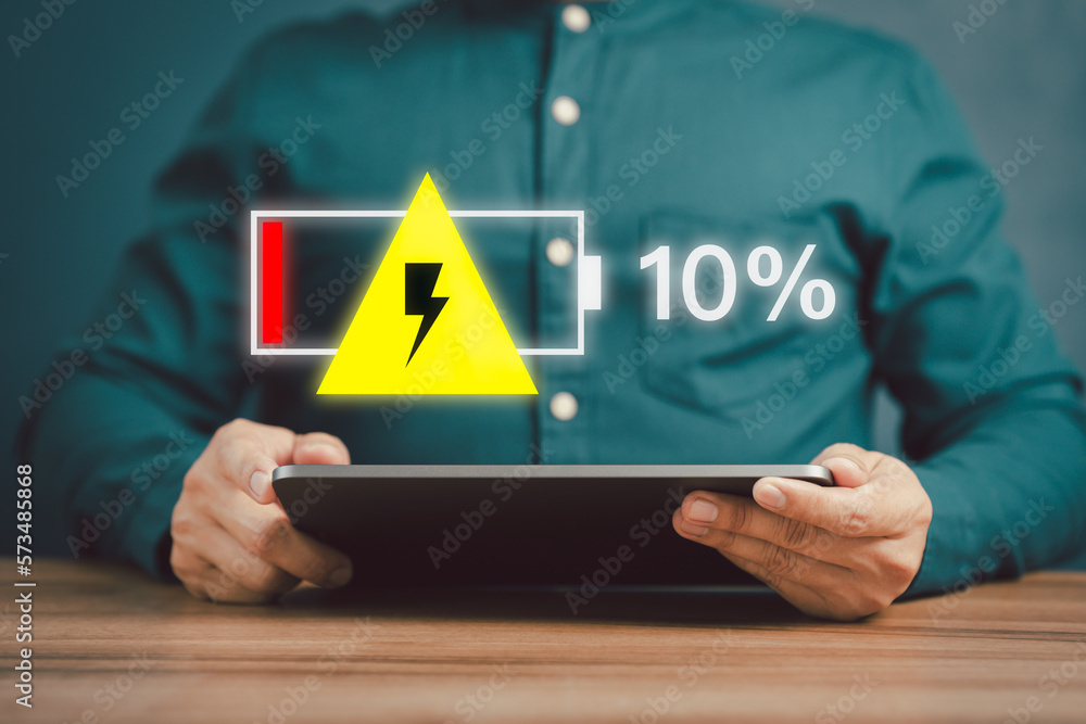 Poster young man is angry and frustrated when he learns that his the tablet's battery is dead and did not b