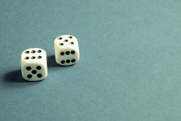 Random number generator. Two white dice with numerical values lie in a chaotic order.