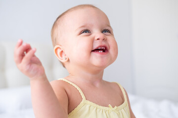 portrait of cute baby girl smiling with first milk teeth. Healthy newborn child