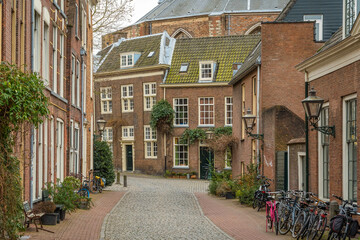 Fototapeta na wymiar Picturesque cobbled street in the historical center of Leiden, South Holland, The Netherlands