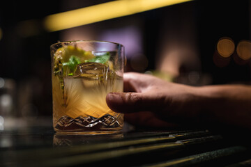 Hand holding a glass of alcohol