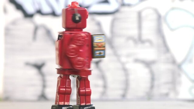 retro red robot marching and spinning outside