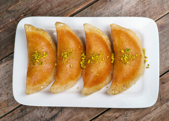 Qatayef, Traditional Arabic Ramadan Sweets on plate.Top view
