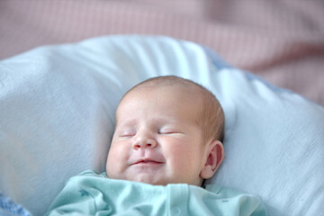 the newborn boy is sleeping. cute beautiful baby is sleeping closeup portrait of a beautiful sleeping baby on white.