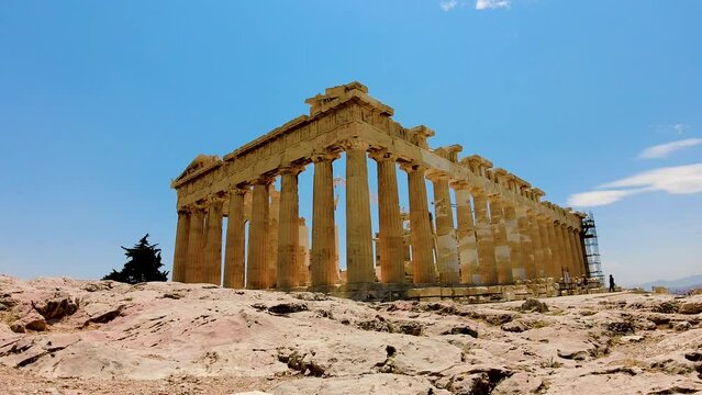 Low angle time lapse of Parthenon on Athenian Acropolis against blue sky; Greece
