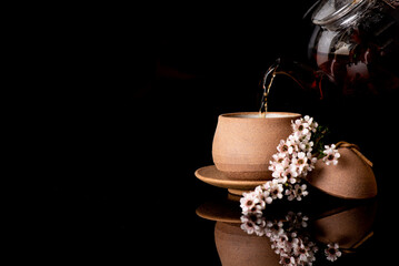 Manuka leaves used as tea to drink on black background.