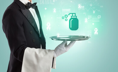 Handsome young waiter in tuxedo holding healthcare icons on tray