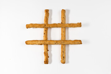 Breadsticks in shape of lattice against white background