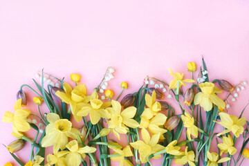 Blossoming light yellow daffodils and spring flowers festive background, bright springtime bouquet floral card