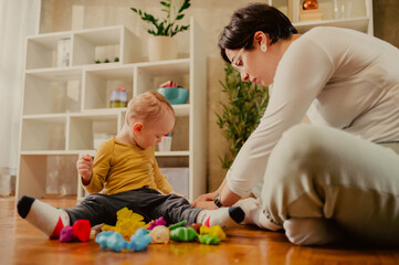 Mother and son playing with clay at home and creating art