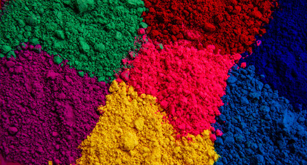 Bright colored background of various powder paints: pink, yellow, blue, green
