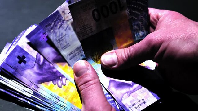 Man Counting 1000 Swiss Franc Banknote to 40.000 in Switzerland.