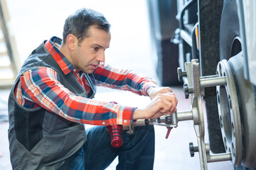 mechanic working on a lorry hub