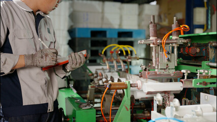 the technician repairing the machine in the factory