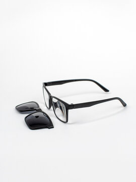 Glasses transformers 2in1 with a magnet. Glasses for computer work. Reading glasses on a white background. Square Black Frame Sunglasses, isolated. Studio shot
