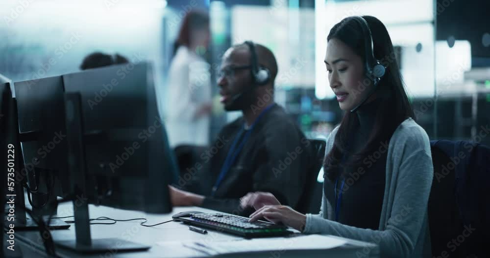 Poster Help Desk Specialist Answering a Call, Providing Technical Support to Client Experiencing Computer Hardware and Software Issues. Asian Female Using a Headset to Have a Conversation with a Tech Team