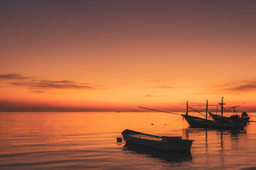 Fototapeta na wymiar Fisherman boats at the sunset sky