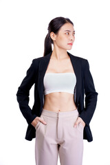 Smiling asiean woman showing abdominal muscles and wearing suit poses in white background.