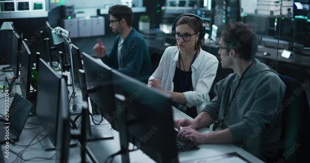 Fototapete Young Team of Specialists Working on Desktop Computers and Having a Conversation at a Workplace. Female and Male Software Developers Discussing a Solution for Their Artificial Intelligence Project