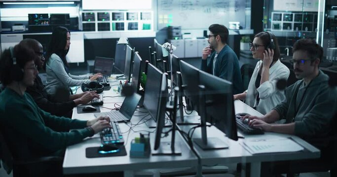 Diverse Young Colleagues Working on Computers in a Research Laboratory. Female Asking Advice from a Male Software Developer Colleague About a Solution for Their Collaborative Industrial Tech Project