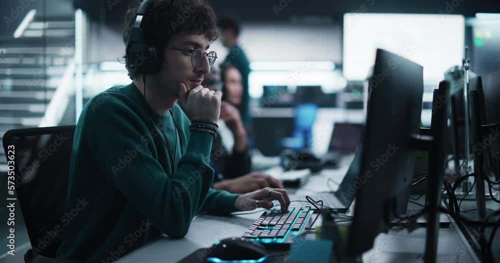 Poster Portrait of a Thoughtful Engineer Working on Desktop Computer in a Technological Office Environment. Research and Development Department Writing Software Code for an Advanced Neural Network Project