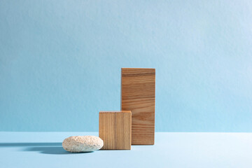 Podiums made of wooden figures, hard shadows. Abstract modern product showcase blue background