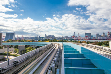 Fototapeta na wymiar Railroad tracks in Japan that pass over highways with views of the metropolis during the day