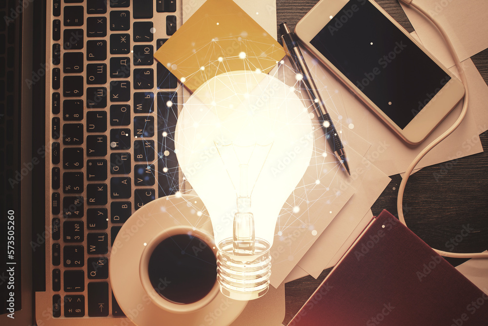 Poster Bulb drawing over computer on the desktop background. Top view. Double exposure. Idea concept.
