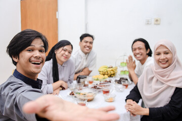 Fototapeta premium POV of young muslim people taking selfie during eid mubarak or break fasting moment.